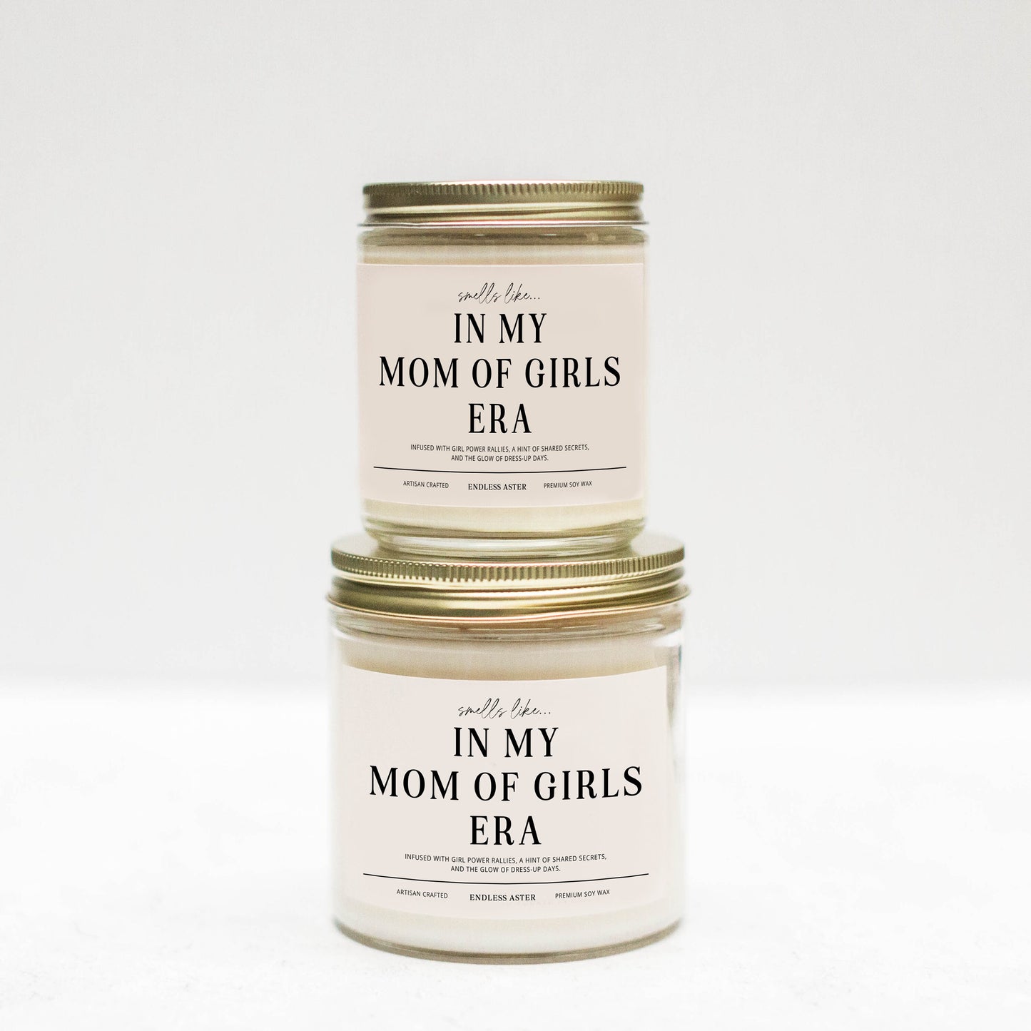 two jars of mom of girls are stacked on top of each other