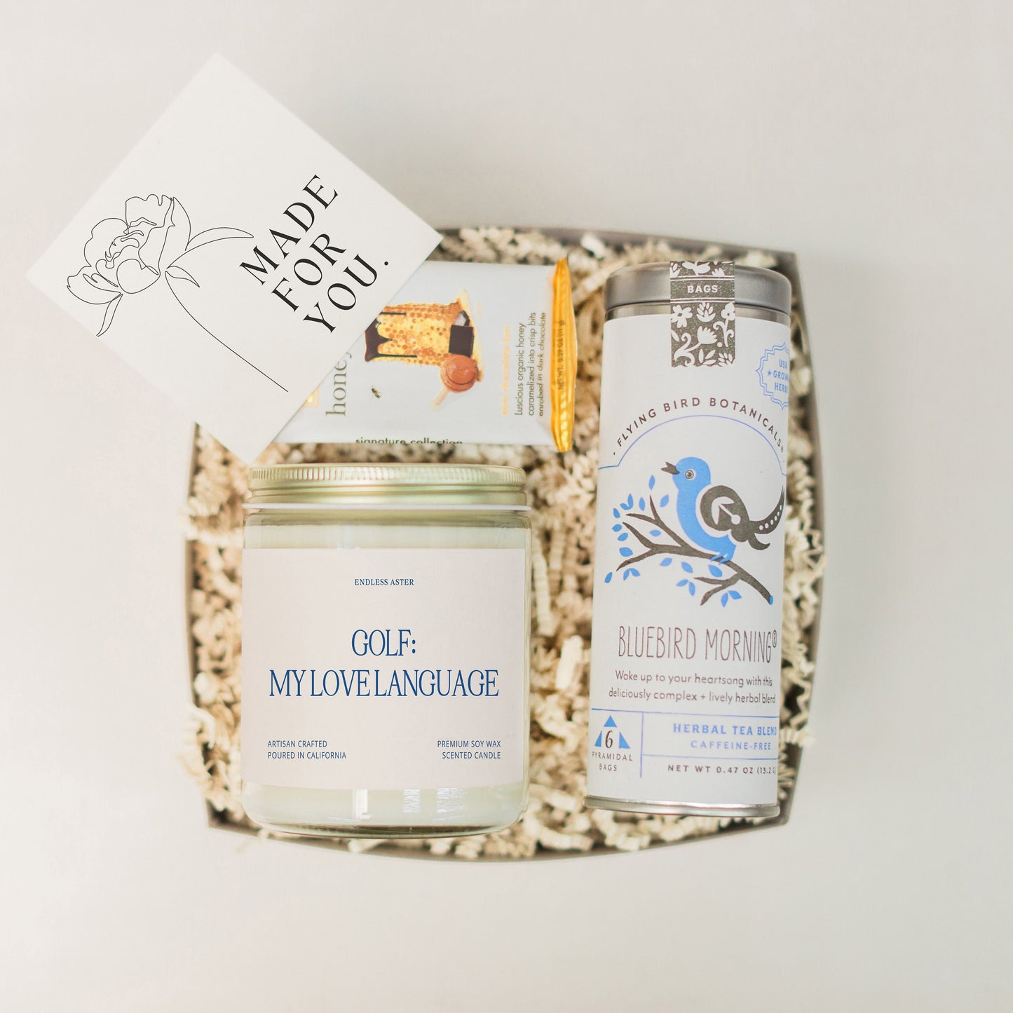 a basket with a jar of honey and a card