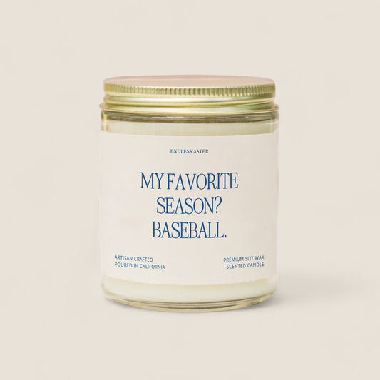 a white candle with a blue label that says, my favorite season? baseball