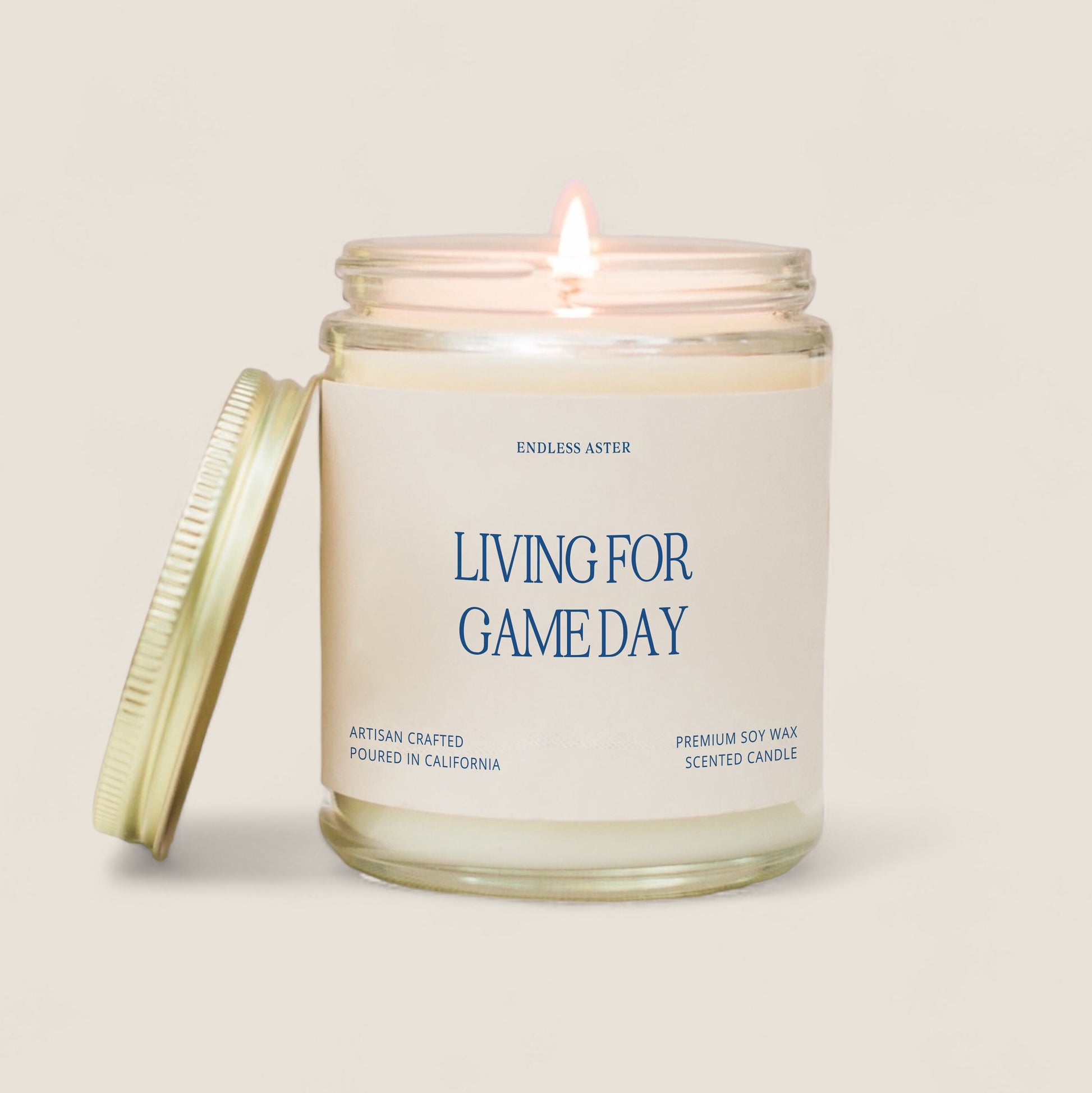 A candle with the saying “living for game day”