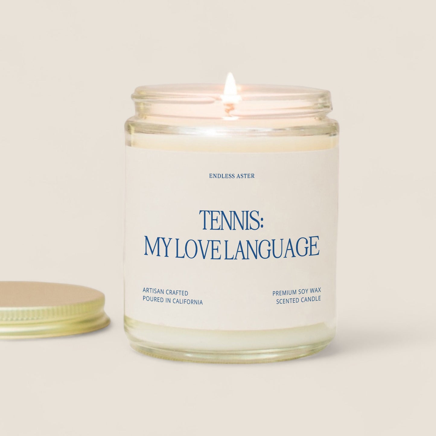 A candle with the saying “tennis: my love language“