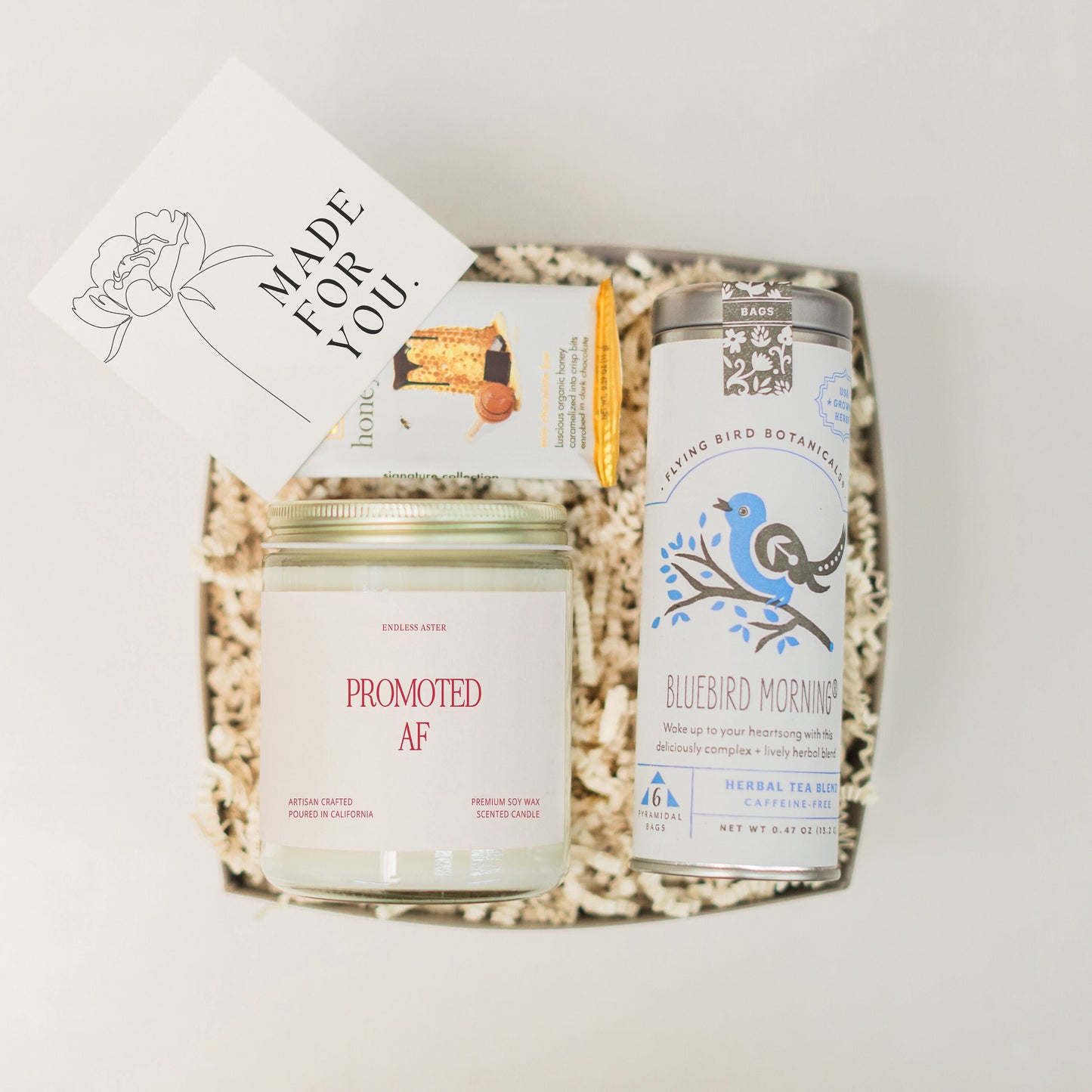 a box with a jar of honey and a card