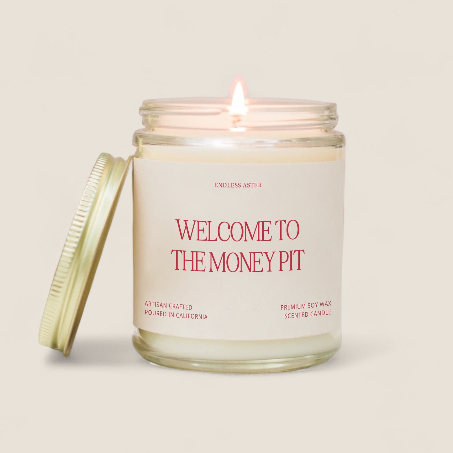 a candle with the words welcome to the money pit on it