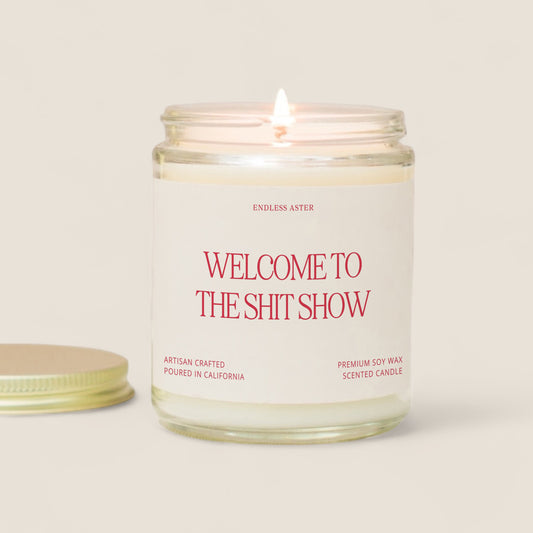 a candle with the words welcome to the shit show on it