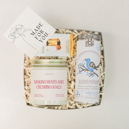 a basket with a jar of cream, a card and some other items